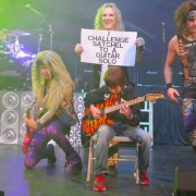 Watch this 11-year old take on a heavy metal band in an epic guitar battle on stage
