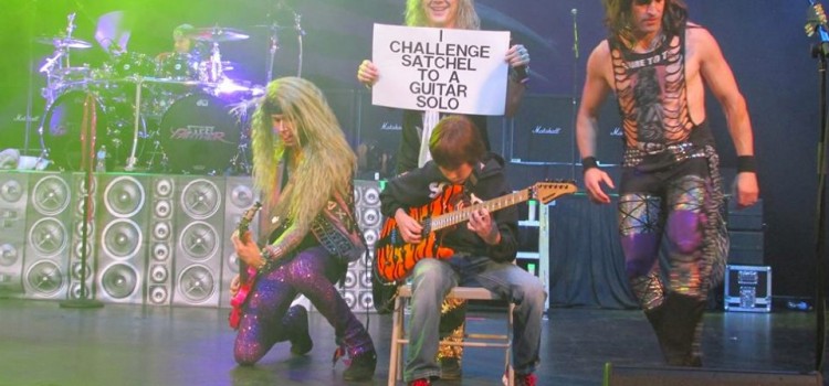 Watch this 11-year old take on a heavy metal band in an epic guitar battle on stage